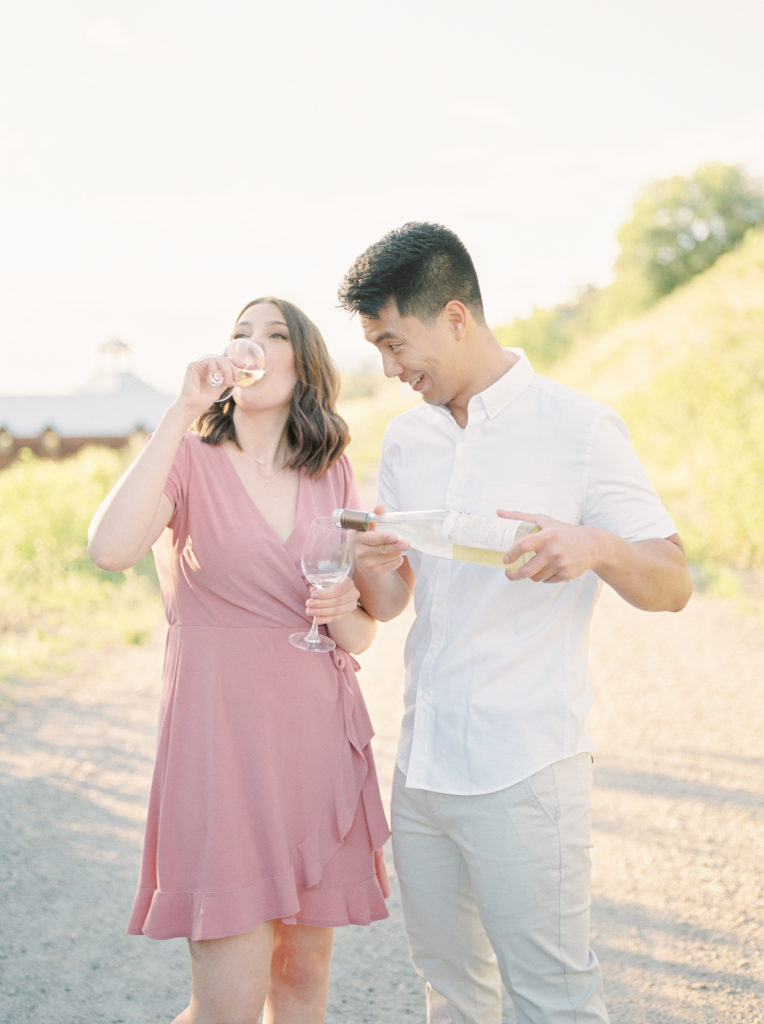 a woman drinks the glass of wine her fiancé poured 