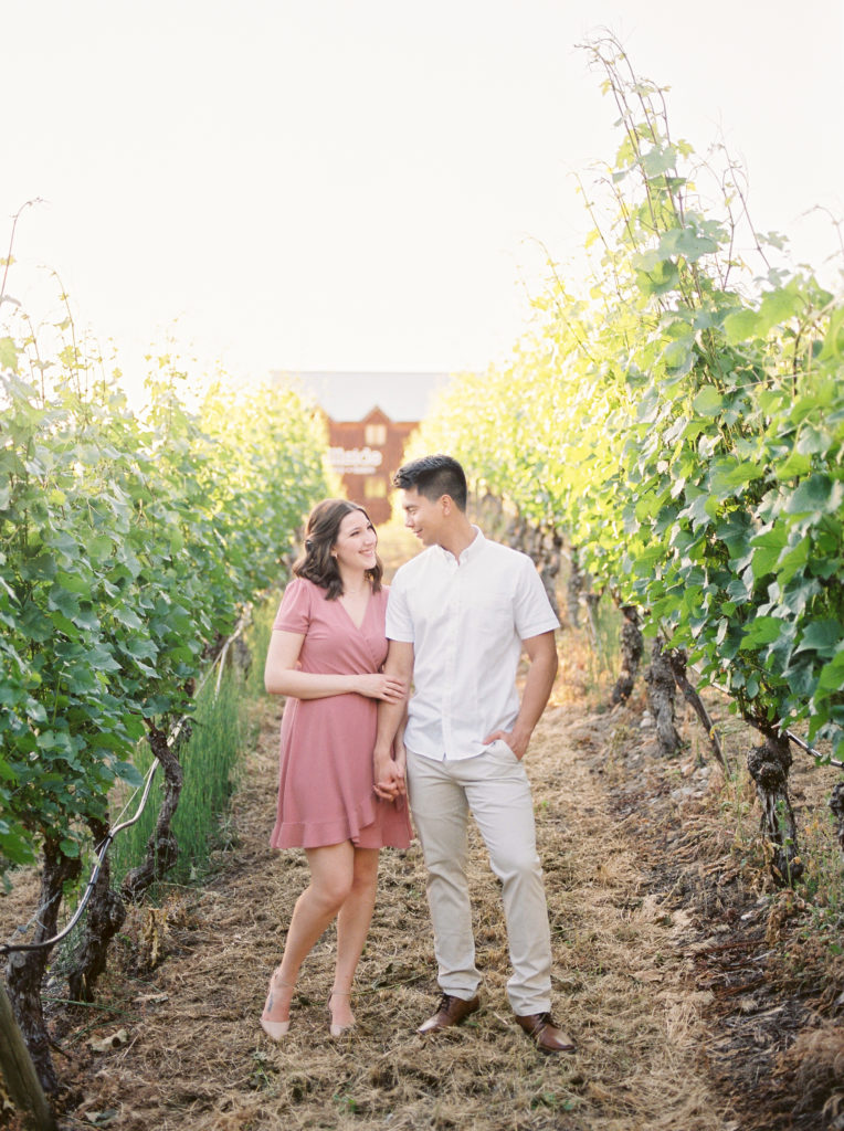 a man and woman pose for photos in the Hillside winery vineyard 
