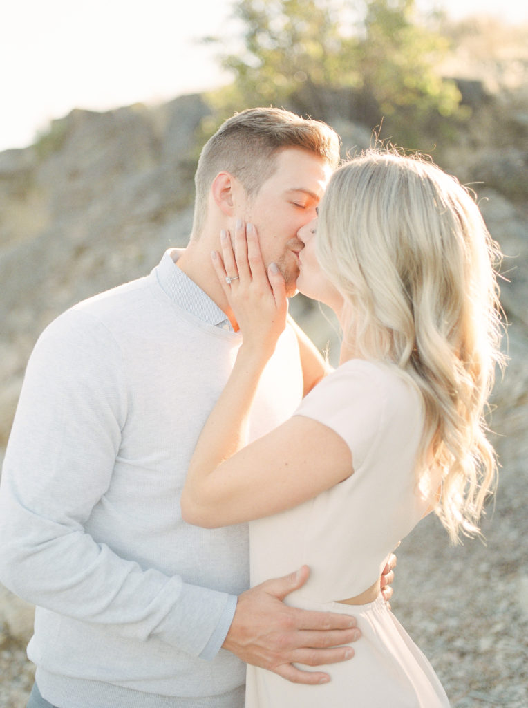 an engaged couple kiss on Kelowna Beach 
