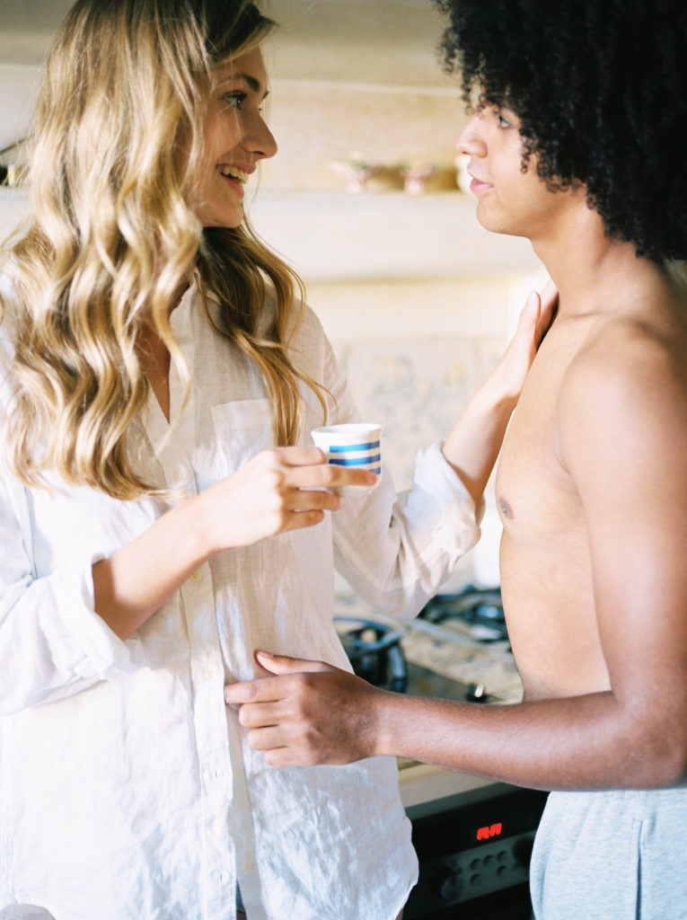 a man and wife share a coffee in the kitchen 
