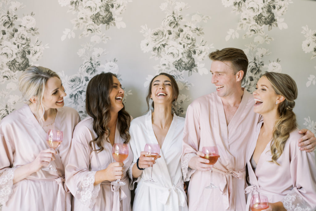 a bride and her bridesmaids in their robes 