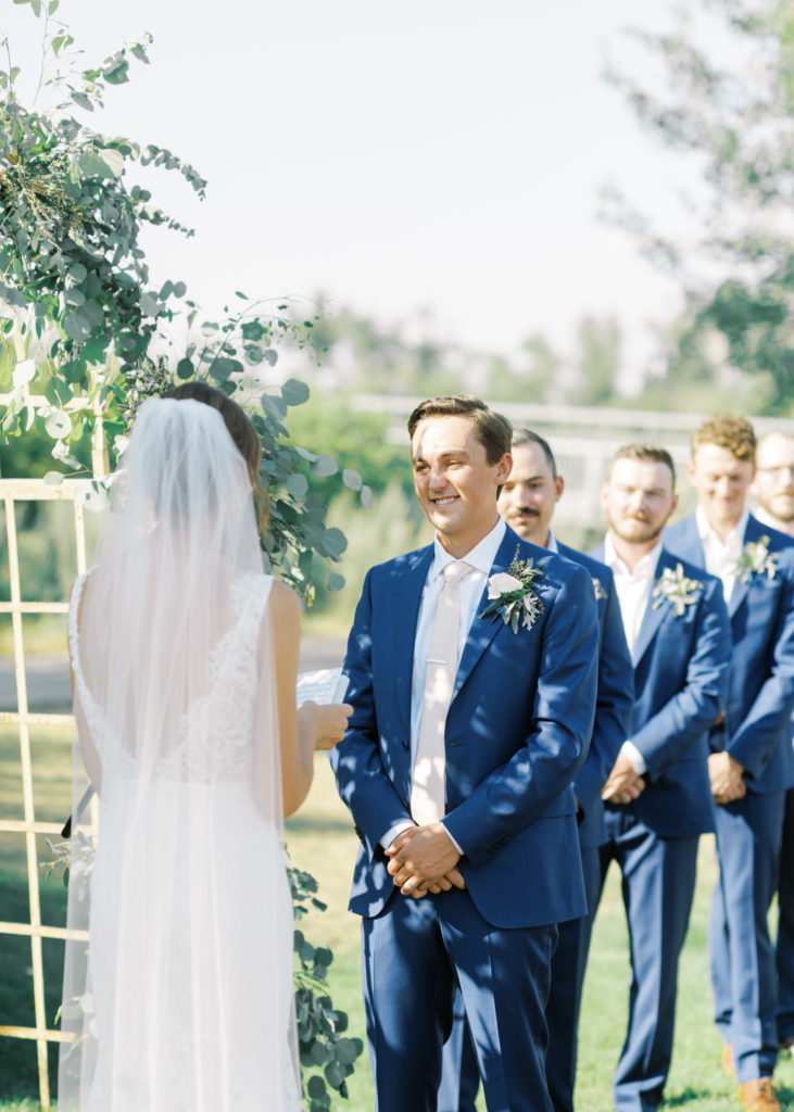 a groom listens to his brides wedding vows 