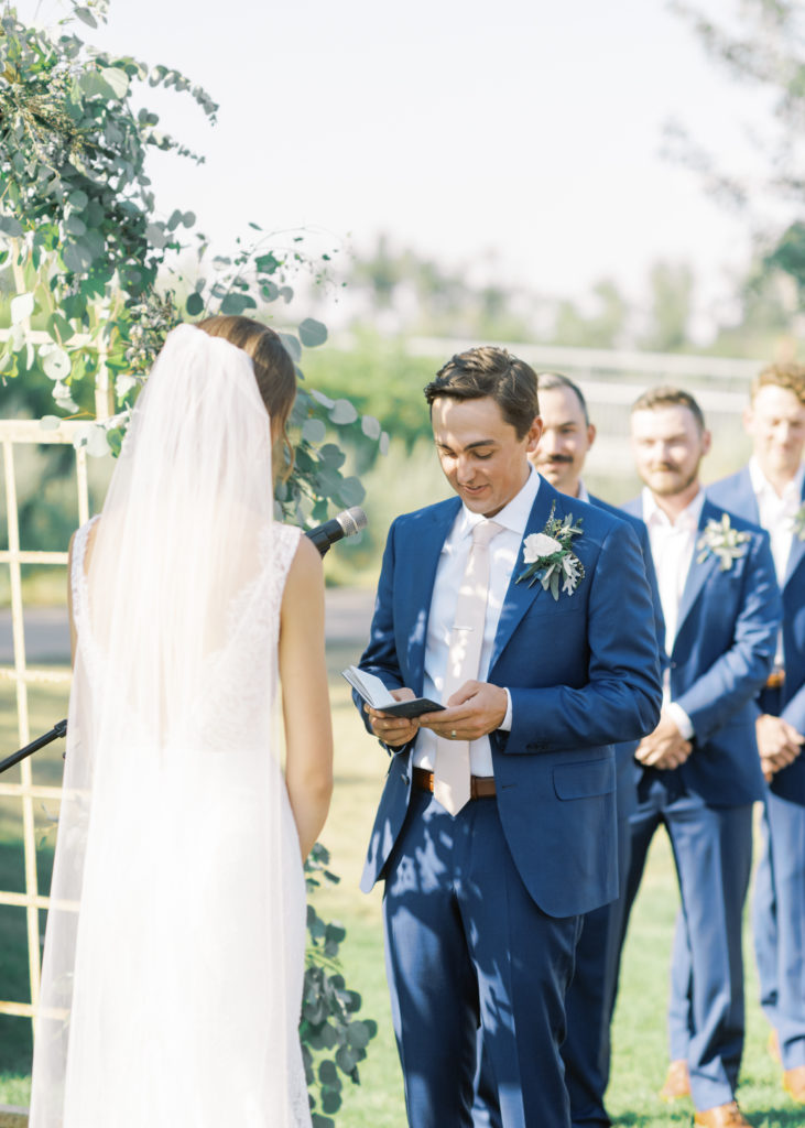 a groom reading his wedding vows 
