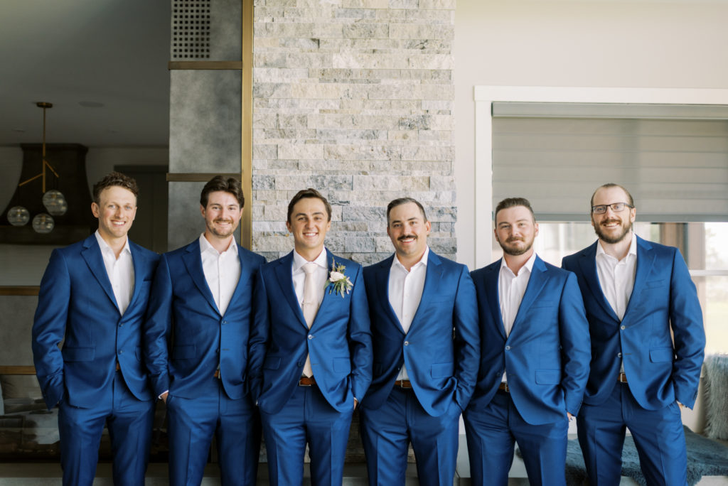 a groom and groomsmen dressed in navy blue suits 