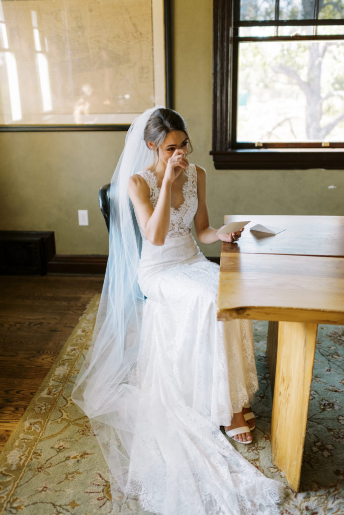a bride crying while reading a letter from her groom 