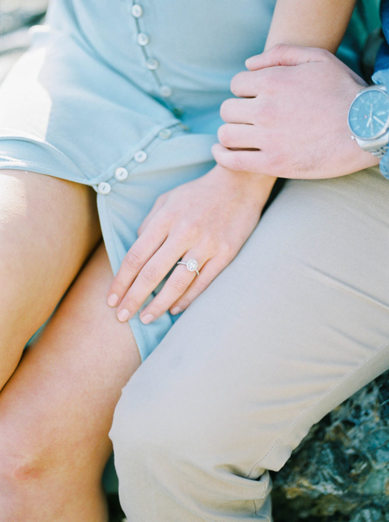 a woman wearing a diamond engagement ring 