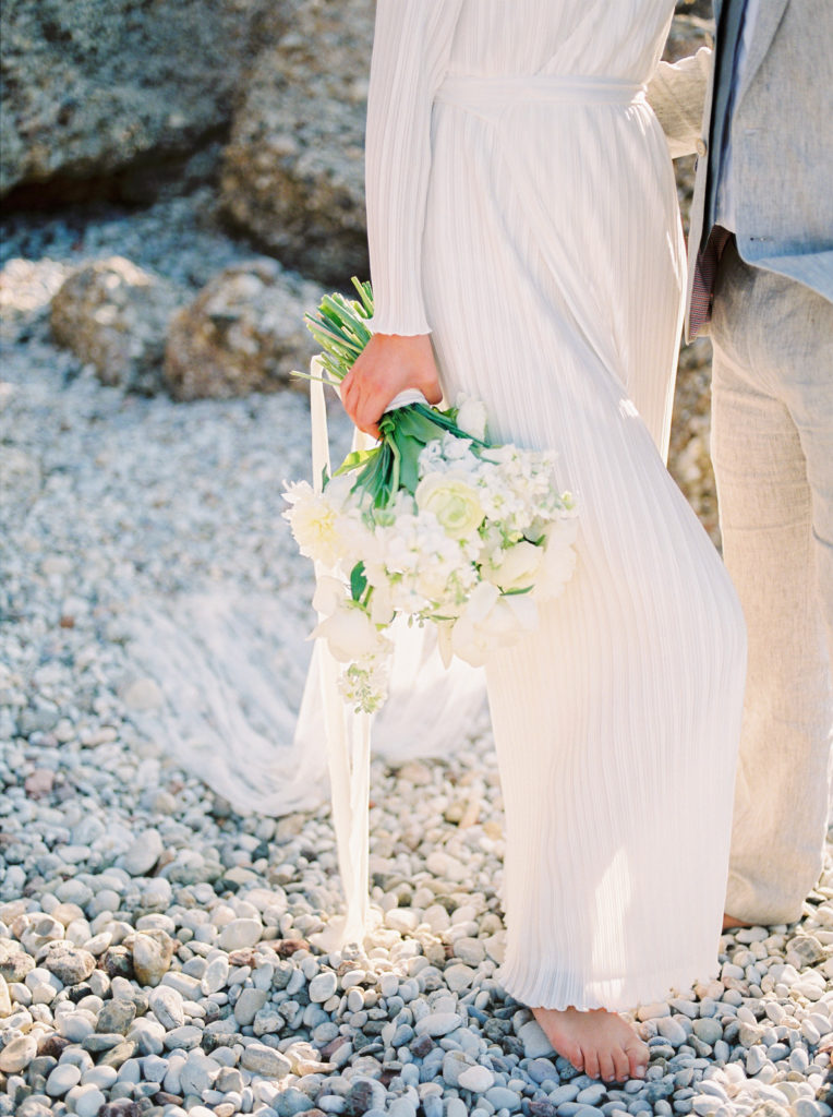 a bride holding her elegant white  bridal bouquet 