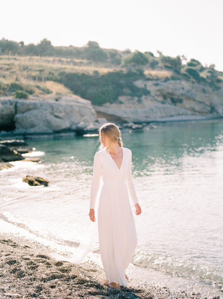 a bride walks barefoot on a Vancouver beach 