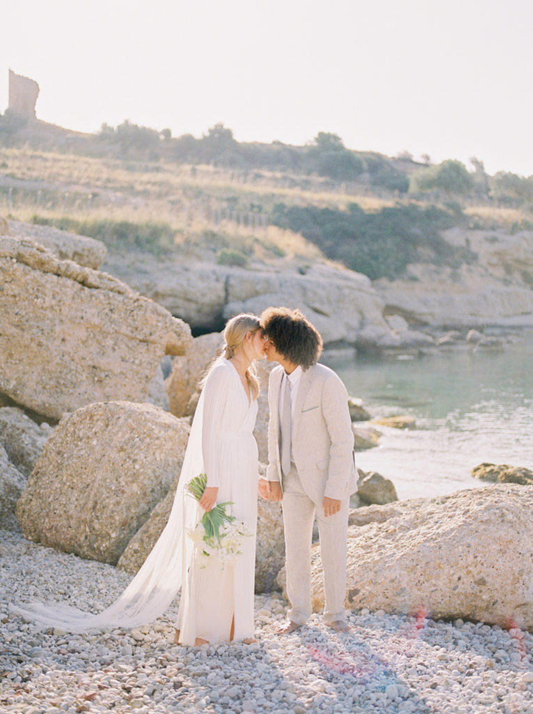 a bride and groom kiss at their Vancouver beach wedding ceremony 