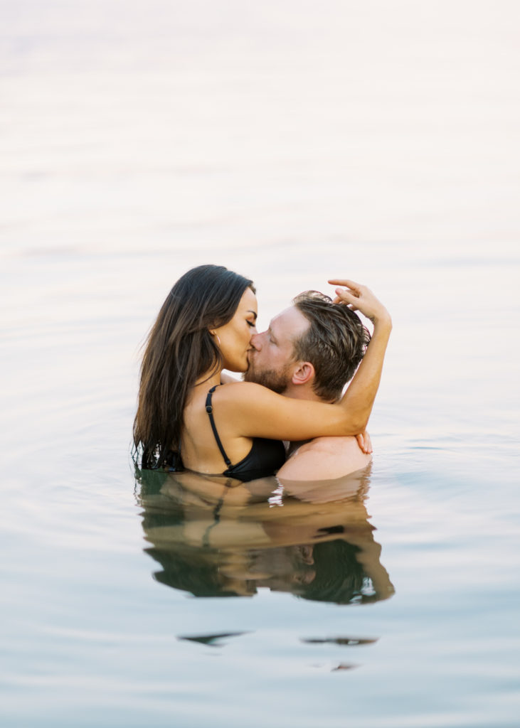 a couple swim in Okanagan lake for their Kelowna beach engagement 