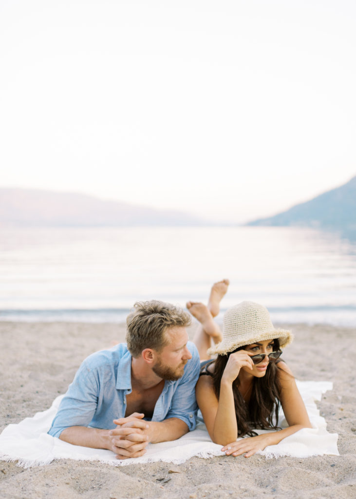 an engaged couple in the sand at their Kelowna beach engagement session 
