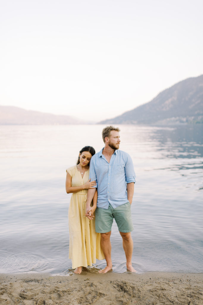 an engaged couple posing for their Kelowna beach engagement photos 