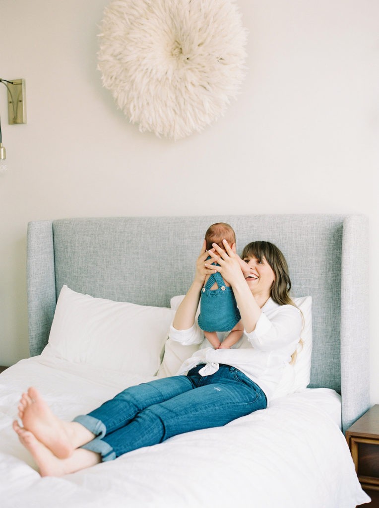 mom plays with baby for Kelowna in home newborn session 