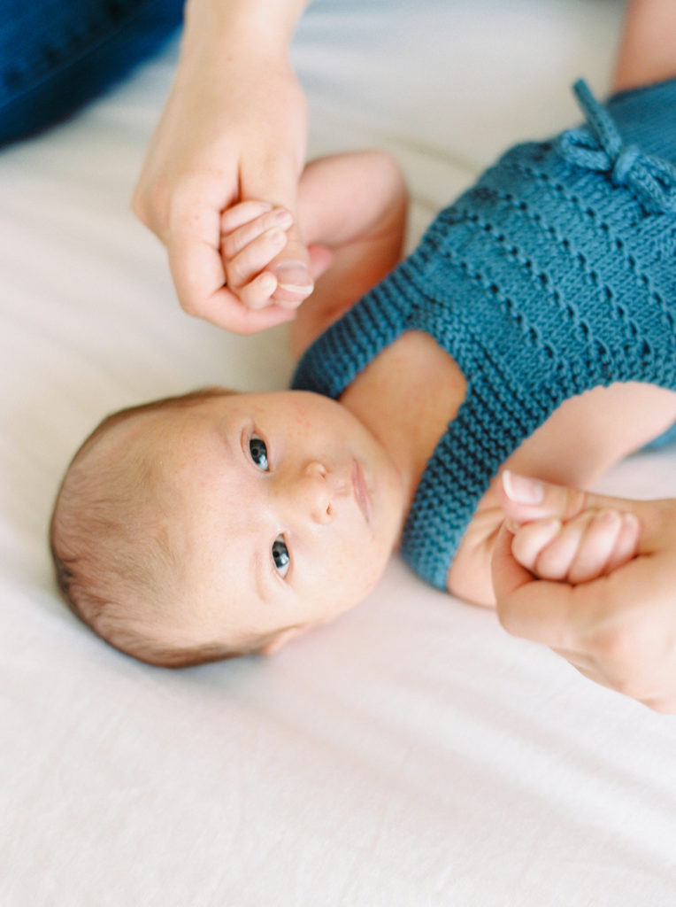 a baby boy dressed in blue for Kelowna in home newborn session 