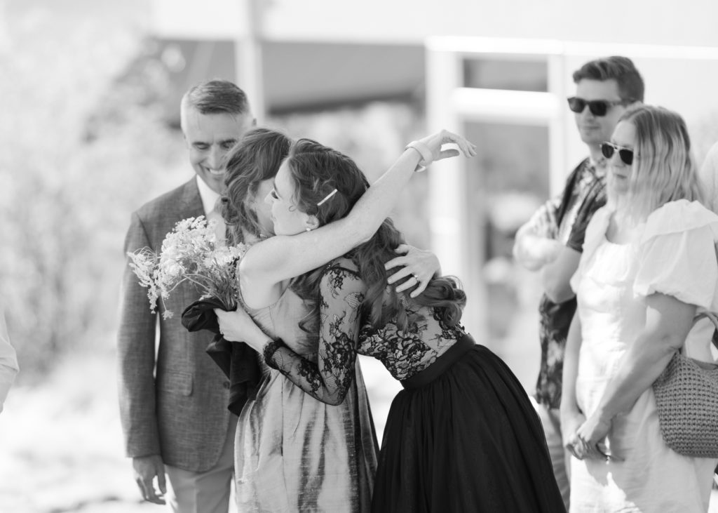 the mother of the bride hugs her daughter at a Kelowna private estate wedding 