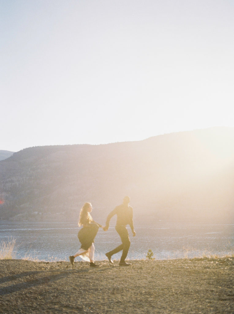 a bride and groom run into the sunset together in Kelowna 