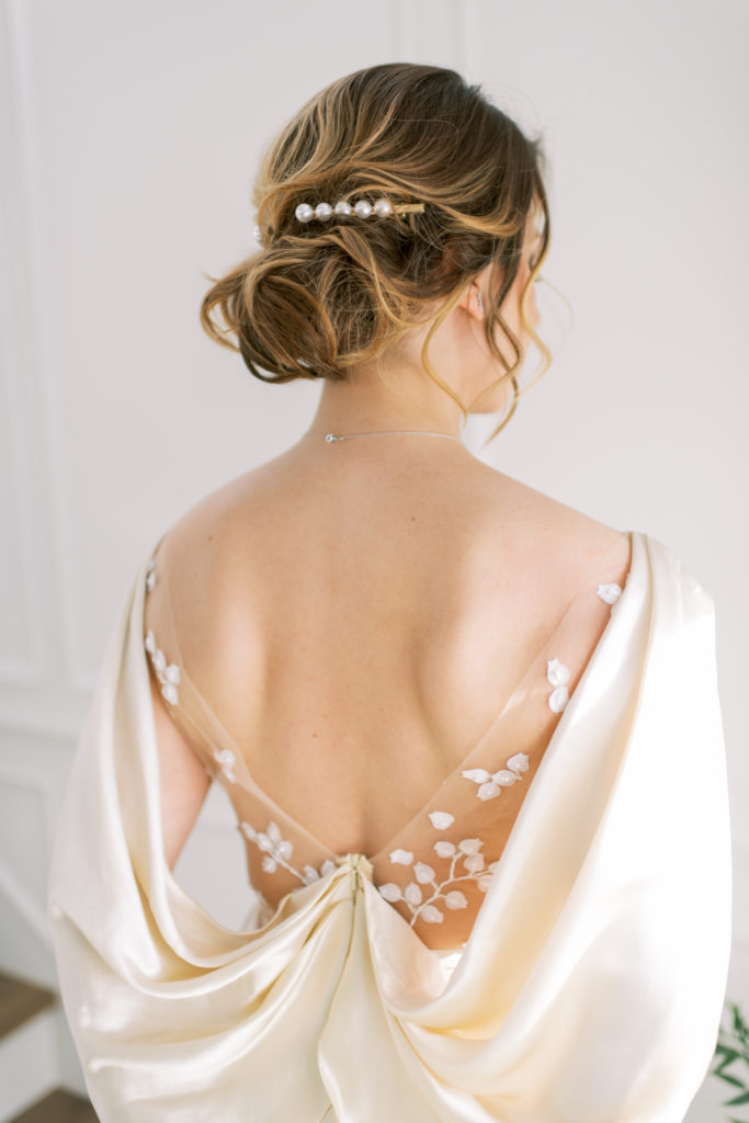 a bridal updo with a pearl hair accessory  