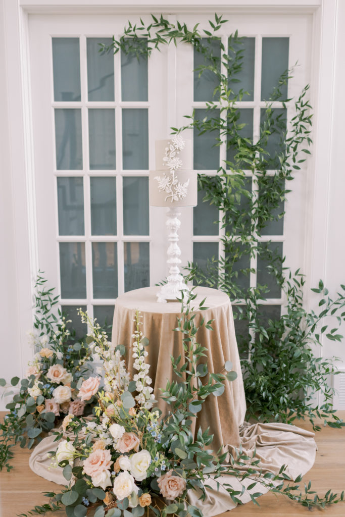 a wedding cake table surrounded by elegant flower arrangements 