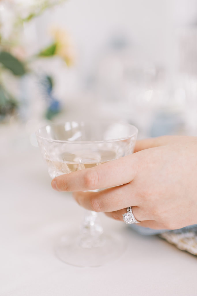 a bride holding a glass of champagne 