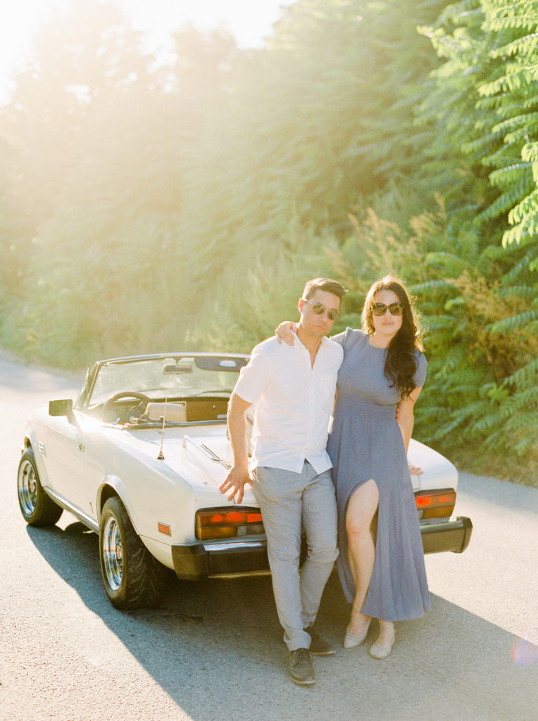 a couple pose with a classic car for their Okanagan couples session 