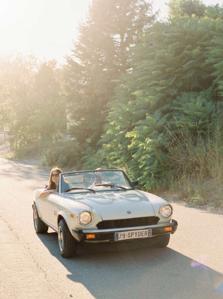 An engaged couple in a classic car in Naramata 