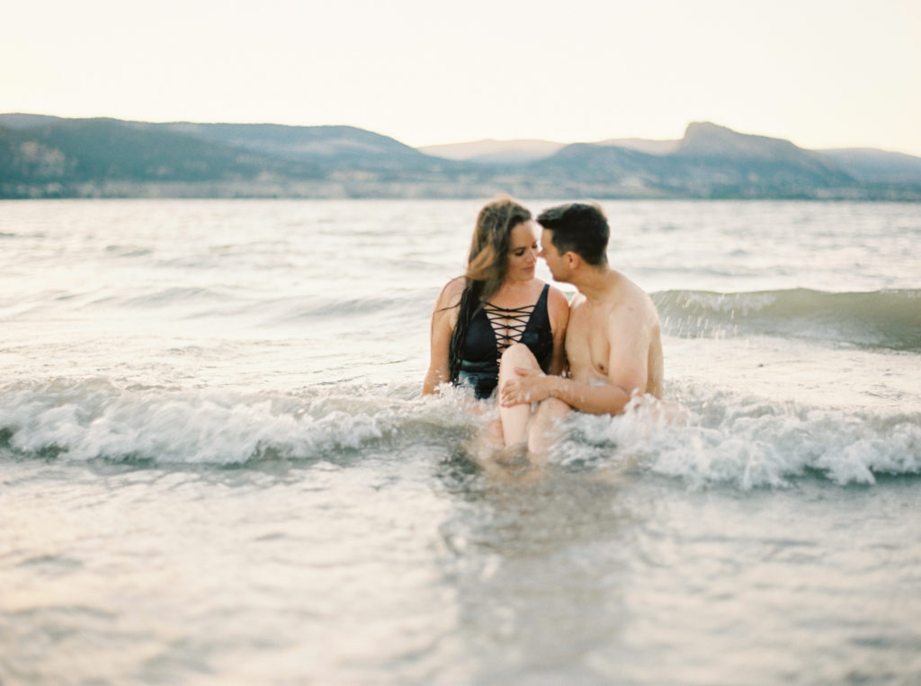 an engaged couple swimming in Okanagan lake 