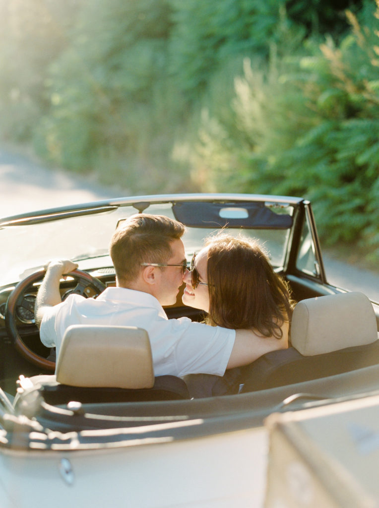 a couple kiss in a classic car during their Okanagan couples session 